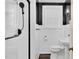 Well-lit bathroom featuring a white pedestal sink, toilet, and tiled shower with a modern shower head at 2120 Cokey Rd, Rocky Mount, NC 27801