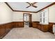Spacious bedroom featuring a ceiling fan, neutral carpet, and wood trim, with a doorway leading to another room at 2120 Cokey Rd, Rocky Mount, NC 27801