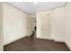 Bedroom features hardwood floors and white walls with three doors at 2120 Cokey Rd, Rocky Mount, NC 27801