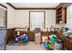 Bedroom featuring built-in cabinets, neutral carpet, and a large window, with various items filling the space at 2120 Cokey Rd, Rocky Mount, NC 27801