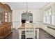 Bright dining area features hardwood floors, a classic china cabinet, and plenty of natural light at 2120 Cokey Rd, Rocky Mount, NC 27801