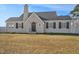 Attractive exterior showcasing gray brick, a black roof, and neat black shutters on a sunny day at 2120 Cokey Rd, Rocky Mount, NC 27801