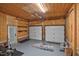 Spacious two car garage featuring painted floor, wood walls and white doors at 2120 Cokey Rd, Rocky Mount, NC 27801