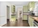 Open kitchen features light green cabinets, stainless appliances, and wood countertops at 2120 Cokey Rd, Rocky Mount, NC 27801
