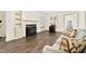 Bright living room featuring a classic fireplace, built-in shelving, and comfortable seating on hardwood floors at 2120 Cokey Rd, Rocky Mount, NC 27801