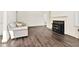 Spacious living room featuring hardwood flooring, a gray couch, and a black fireplace at 2120 Cokey Rd, Rocky Mount, NC 27801