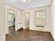 Living room view into kitchen and bathroom with wood floors and natural light at 2120 Cokey Rd, Rocky Mount, NC 27801