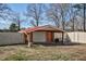 Red metal outbuilding with covered bay next to white vinyl fence at 2120 Cokey Rd, Rocky Mount, NC 27801