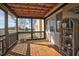 Screened patio with wood deck, featuring a wicker shelf and view of backyard at 2120 Cokey Rd, Rocky Mount, NC 27801