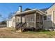View of tan two-story home featuring a screened porch and access to garage at 2120 Cokey Rd, Rocky Mount, NC 27801