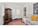 Bright sunroom with a vintage cabinet, comfortable seating, and ample natural light at 2120 Cokey Rd, Rocky Mount, NC 27801