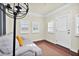 Cozy sunroom area featuring a comfortable couch, bright windows, and a decorative light fixture at 2120 Cokey Rd, Rocky Mount, NC 27801