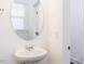 Powder bathroom with oval mirror and pedestal sink with chrome fixtures at 22 Twin Birch Dr, Angier, NC 27501
