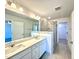 A modern bathroom features dual sinks, a large mirror, and a glass-enclosed walk-in shower at 22 Twin Birch Dr, Angier, NC 27501