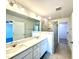 A modern bathroom features dual sinks, a large mirror, and a glass-enclosed walk-in shower at 22 Twin Birch Dr, Angier, NC 27501