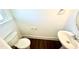 Powder room with a pedestal sink, toilet, and hardwood flooring at 22 Twin Birch Dr, Angier, NC 27501