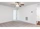 Large bedroom with carpet, ceiling fan, and a hallway to the right with a bathroom adjacent at 22 Twin Birch Dr, Angier, NC 27501