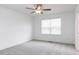 Bedroom with neutral carpet, ceiling fan, and large window with blinds offering plenty of natural light at 22 Twin Birch Dr, Angier, NC 27501