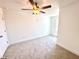 A cozy bedroom is carpeted with light neutral paint and a ceiling fan to provide light and air circulation at 22 Twin Birch Dr, Angier, NC 27501