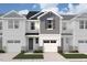 A new construction townhouse boasts a one-car garage, neutral tones, stone accents, and landscaping at 22 Twin Birch Dr, Angier, NC 27501