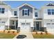 New construction townhouse exterior features stone accents, a one-car garage, landscaped front yard, and neutral colors at 22 Twin Birch Dr, Angier, NC 27501