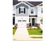 Front exterior featuring a garage, driveway and small landscaping at 22 Twin Birch Dr, Angier, NC 27501