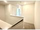 An upstairs hallway features white trim and carpet flooring, with stairs leading down to the lower level of the house at 22 Twin Birch Dr, Angier, NC 27501