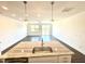 Open concept kitchen with a large island, stainless steel sink, modern lighting, and hardwood floors at 22 Twin Birch Dr, Angier, NC 27501