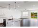 Kitchen island with stainless dishwasher and granite countertops in an open floorplan at 22 Twin Birch Dr, Angier, NC 27501