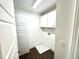 A functional laundry room features overhead cabinets, sleek countertops, and modern fixtures at 22 Twin Birch Dr, Angier, NC 27501