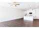 Spacious living room with wood-look floors, ceiling fan, and an open concept to the kitchen at 22 Twin Birch Dr, Angier, NC 27501