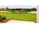 Community playground with swings, slides, and picnic tables, all surrounded by lush green grass at 22 Twin Birch Dr, Angier, NC 27501