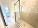 A modern glass-enclosed shower showcases tiled walls, shower accessories, and great natural light at 22 Twin Birch Dr, Angier, NC 27501