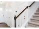 Staircase with brown handrail and white posts leading to the second story at 22 Twin Birch Dr, Angier, NC 27501