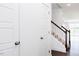 Staircase with brown handrail and white posts leading to an open floor plan at 22 Twin Birch Dr, Angier, NC 27501