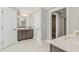 Stylish bathroom with double vanity, wood cabinets, white countertops, and a walk-in closet at 243 Augusta Pond Way # 163, Raleigh, NC 27603