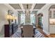 Formal dining room boasts coffered ceilings, hardwood floors, and ample natural light from large windows at 243 Augusta Pond Way # 163, Raleigh, NC 27603