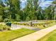Outdoor fitness area along a sidewalk with exercise equipment surrounded by landscaping at 247 Augusta Pond Way # 164, Raleigh, NC 27603