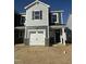 New two story home with gray siding, white garage door, and an inviting front porch at 25 Silver Pne Dr, Angier, NC 27501