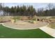 Community playground featuring a slide, climbing structure, and grassy areas at 269 Beacon Dr, Pittsboro, NC 27312