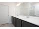 Modern bathroom featuring double sinks, large mirror, and a glass-enclosed shower, offering a spa-like experience at 272 Beacon Dr, Pittsboro, NC 27312