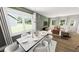Elegant dining room with large windows, modern chandelier, and open access to the living room at 272 Beacon Dr, Pittsboro, NC 27312