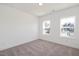 Well-lit bedroom with neutral carpeting, two windows and views of the neighborhood at 280 Beacon Dr, Pittsboro, NC 27312