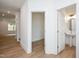 Bright hallway with wood floors showing an open room and a powder room at 280 Beacon Dr, Pittsboro, NC 27312