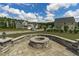 Landscaped backyard with stone fire pit and well-manicured lawn at 2801 Landon Ridge Dr, New Hill, NC 27562