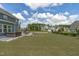 Expansive backyard with a patio, hot tub, outdoor dining area, and well-kept lawn at 2801 Landon Ridge Dr, New Hill, NC 27562