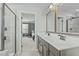 Bright bathroom featuring a double sink vanity, walk-in shower with gray tile, and doorway to the bedroom at 2801 Landon Ridge Dr, New Hill, NC 27562