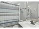 Neutral bathroom featuring a striped shower curtain, single vanity, and decorative mirror at 2801 Landon Ridge Dr, New Hill, NC 27562