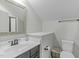 Bright bathroom features a modern vanity, large mirror, and toilet with gray walls at 2801 Landon Ridge Dr, New Hill, NC 27562