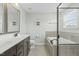 Bright bathroom featuring a double sink vanity, soaking tub, and bronze fixtures at 2801 Landon Ridge Dr, New Hill, NC 27562